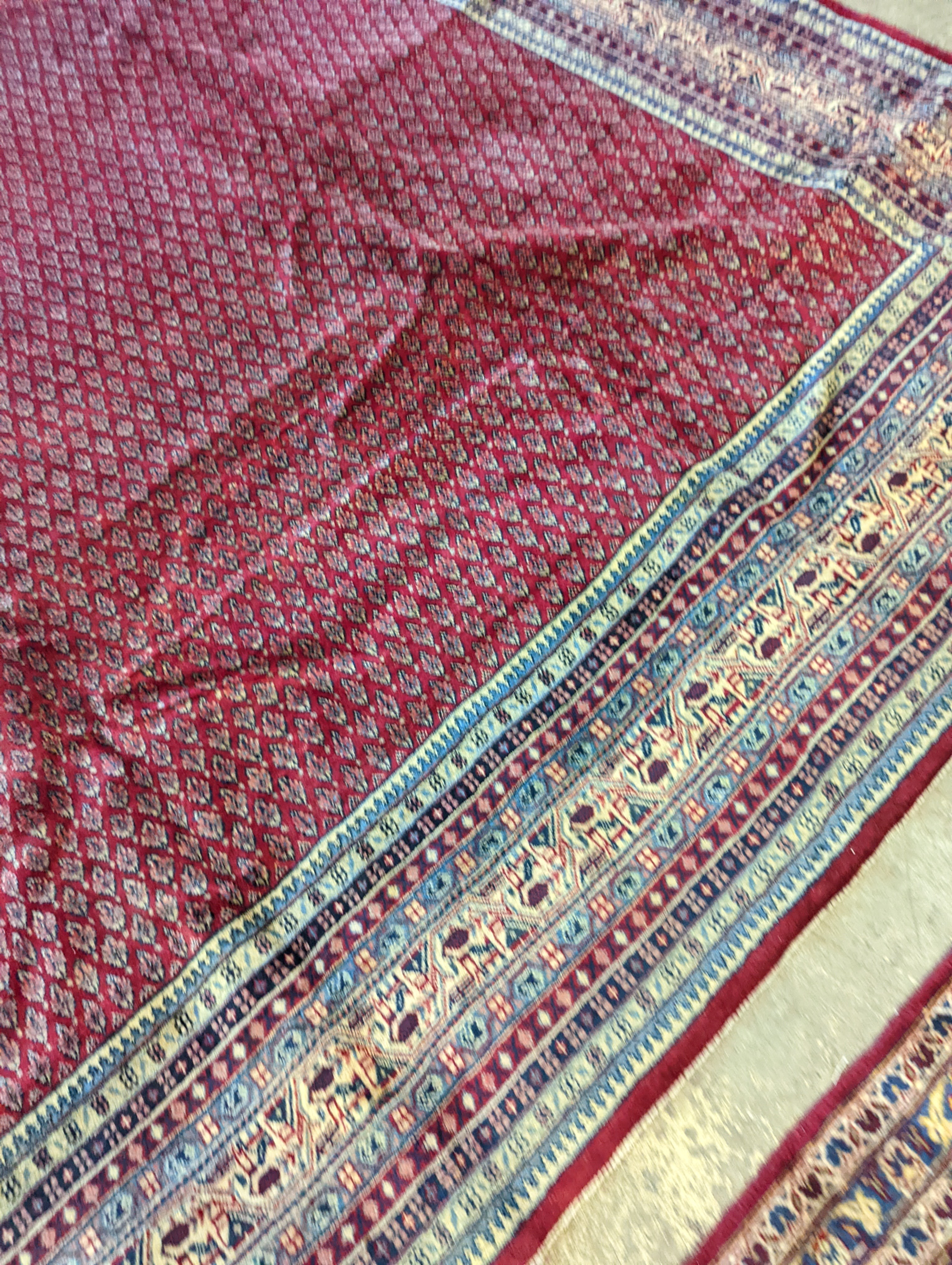 An Araak crimson ground carpet, 350 x 250cm